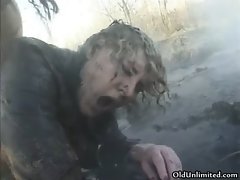 Dirty old mom covered with mud gets